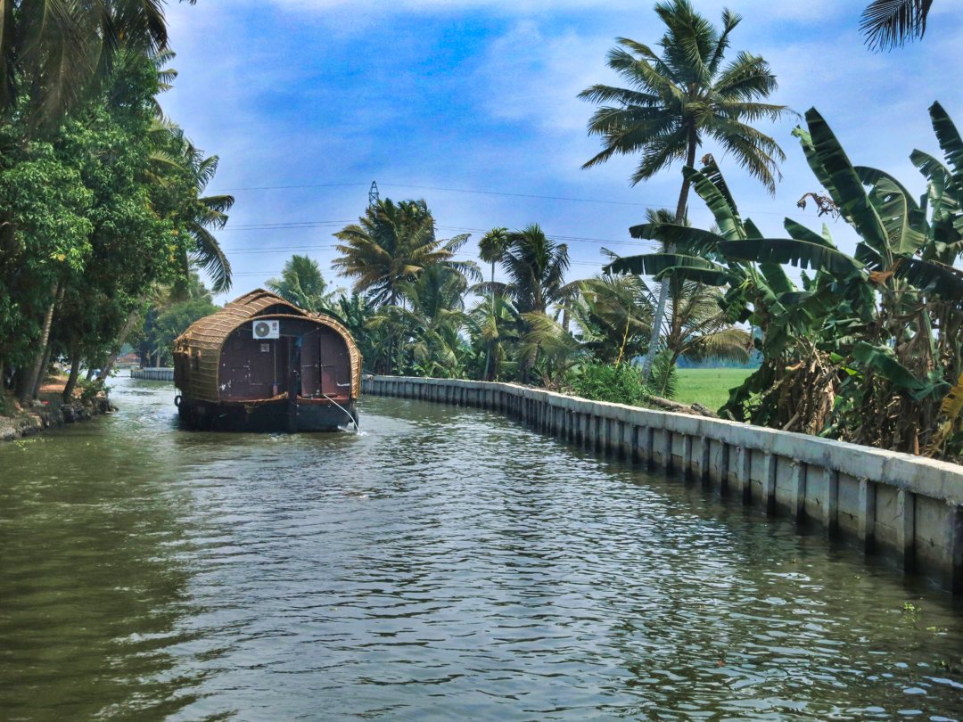 save money while you travel; Alleppey Canal; houseboat; Kerala; sky; white clouds; trees; uasatish; Save Money While You Travel;